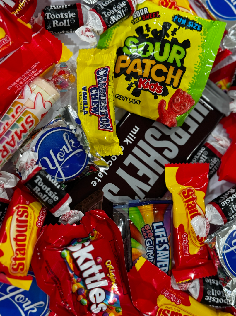 Popular Halloween candies scattered around.