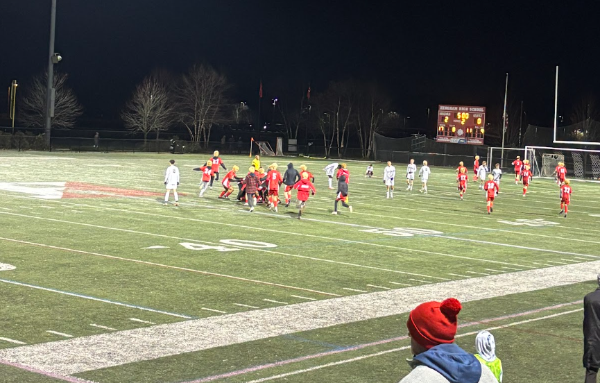 The Hingham boys’ team crowds at the center of the pitch after their 2-0 win against Minnechaug, propelling them to the Final 4. 