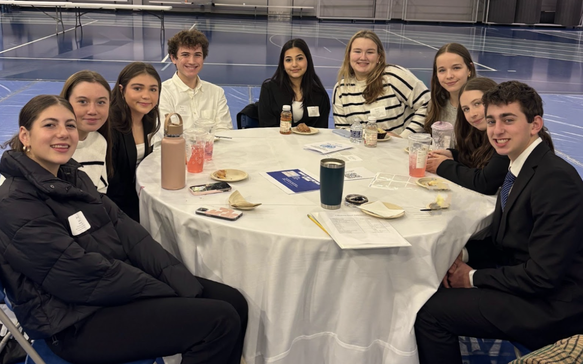 9 Hingham students, (from left to right) Izzy Stolzman, Maddie Everett, Abbey George, Owen Lefort, Gianna Aljanabi, Taylor Ferrante, Grace Moore, and Dory Maguire) participated in the Model UN Conference at St John’s Prep