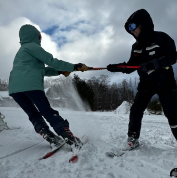 The Stowe instructor, Jessie (right), who stays with the team from 9 AM - noon, doing a ski drill with sophomore Isabel Dubose (left).
