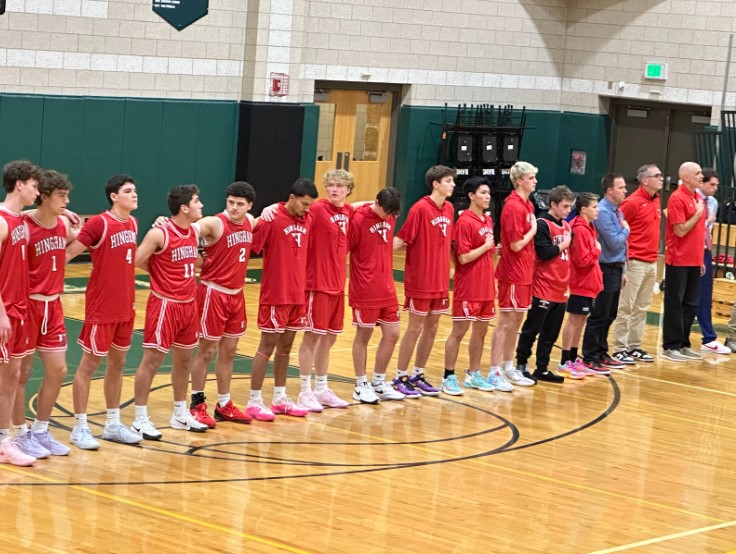 (The Hingham boys varsity basketball team during the singing of the national anthem before their game against Marshfield High School.  Photo credits: Vivien Nicholas)
