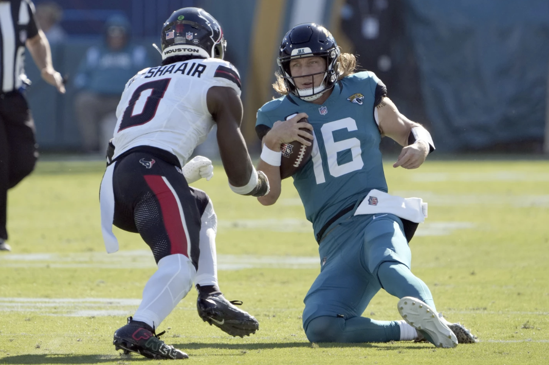 Houston Texans’ linebacker Azeez Al-Shaair (0) looks to take down a sliding Trevor Lawrence (Jacksonville Jaguars QB #16). The dirty hit suspended Al-Shaair and injured Lawrence, which can effect fantasy owners on both ends. 