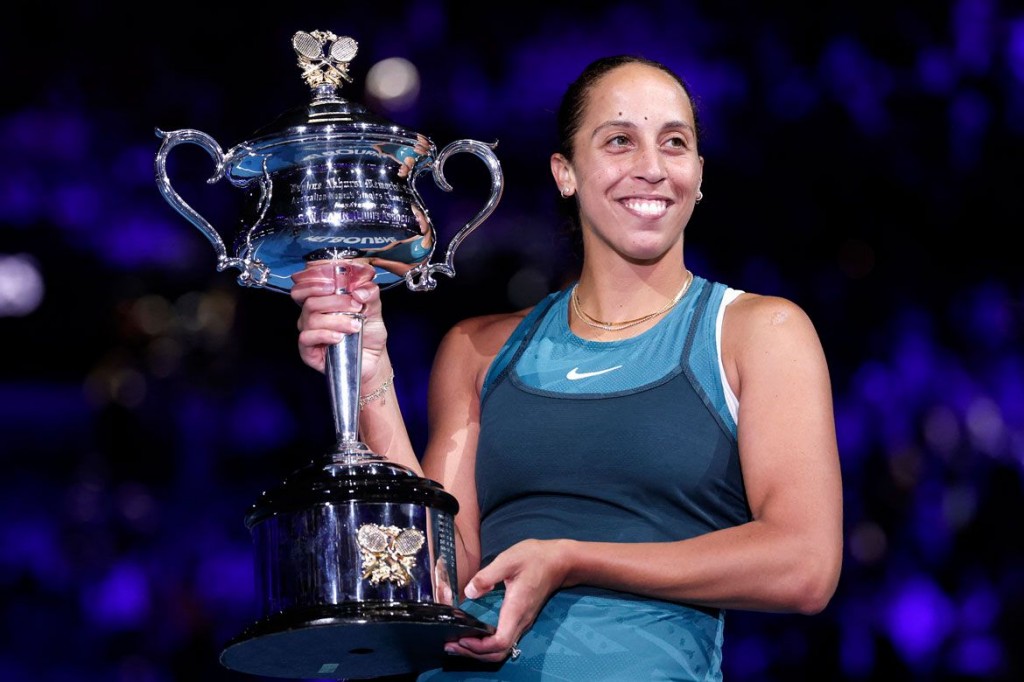 Madison Keys hoists her first career Grand Slam trophy.