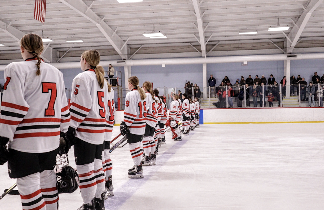 The girl’s hockey team lines up for the national anthem before getting their ninth win of the season.