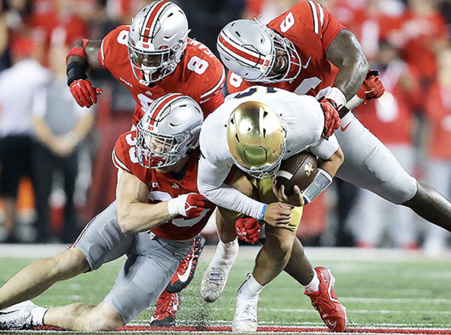 Three Ohio State players tackle a Notre Dame Player.