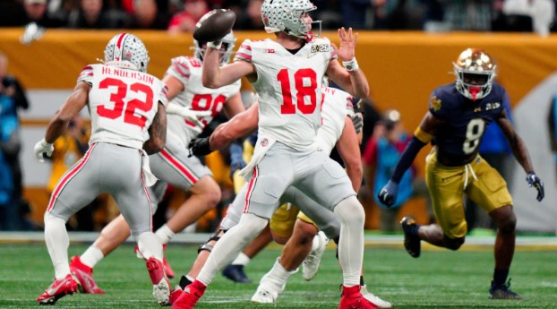 Ohio State quarterback Will Howard (18) leading his team to their first national championship in 10 years. (Jacob Kupferman)
