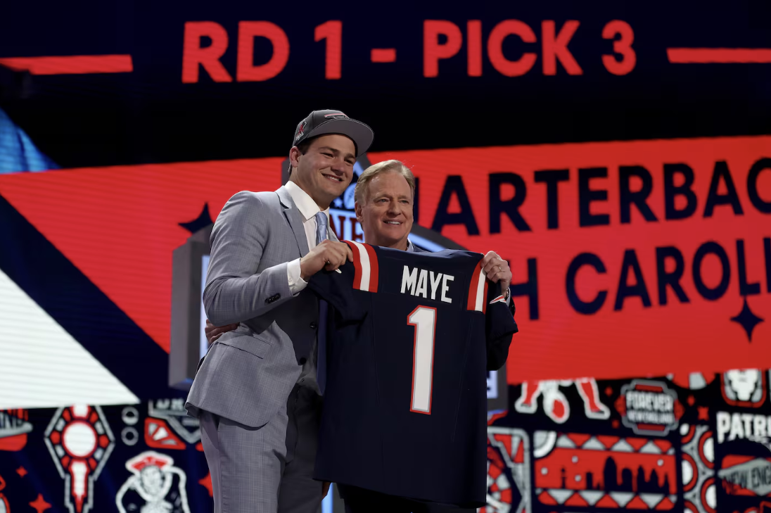 Drake Maye poses alongside NFL Commissioner Roger Goodell after being drafted third overall by the Patriots.