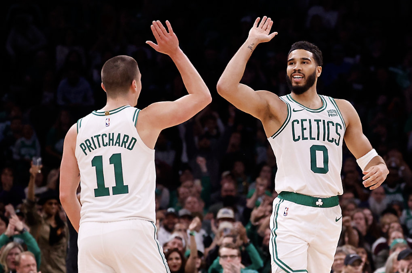 Jayson Tatum high fives Peyton Phitchard after a made shot against the 76ers