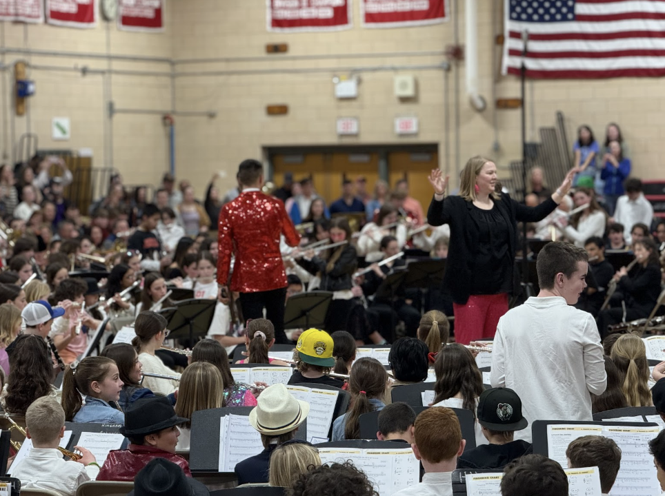 Mr. Cincotta and Mrs. Crook conduct the fifth and sixth grade bands as they play “You Belong With Me” by Taylor Swift in the HHS gym.