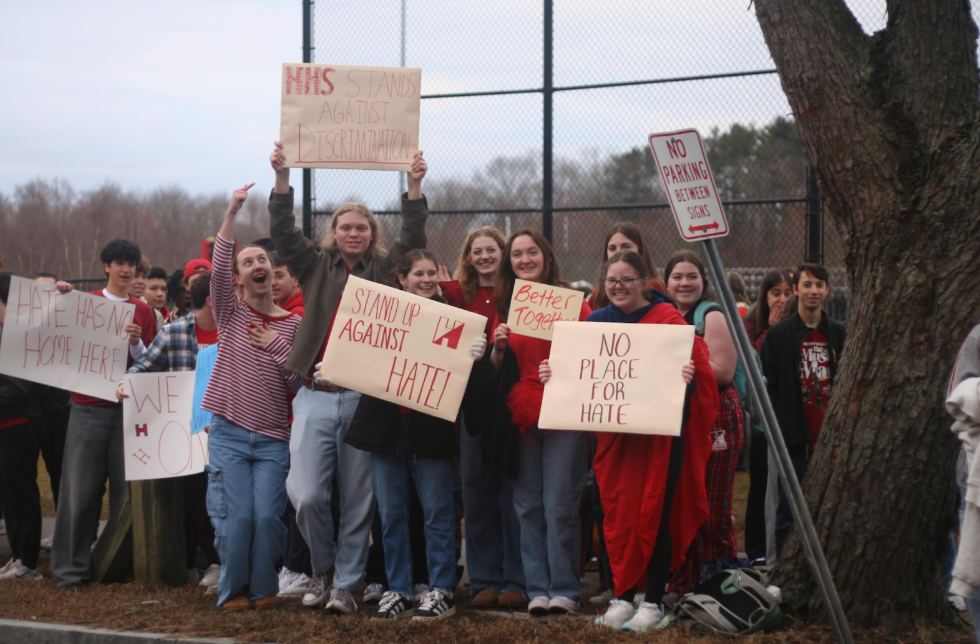 HHS students Luke Burke, Harry Fitzgerald, Lauren Walker, Clare Blatchley, Tag Tomlinson, Breanna Weiss, and Annie Daly (pictured left to right) hold up anti-hate signs on Thursday’s rally. 