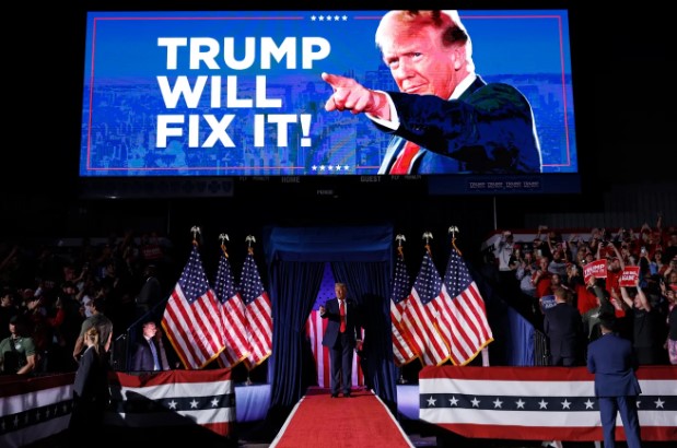 President Donald J. Trump at a rally back in November 2024. The sign reads the message he pushed about the economy.
