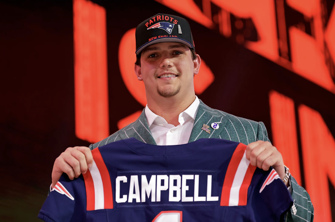 LSU offensive tackle Will Campbell proudly hoists his Patriots jersey after being drafted fourth overall.