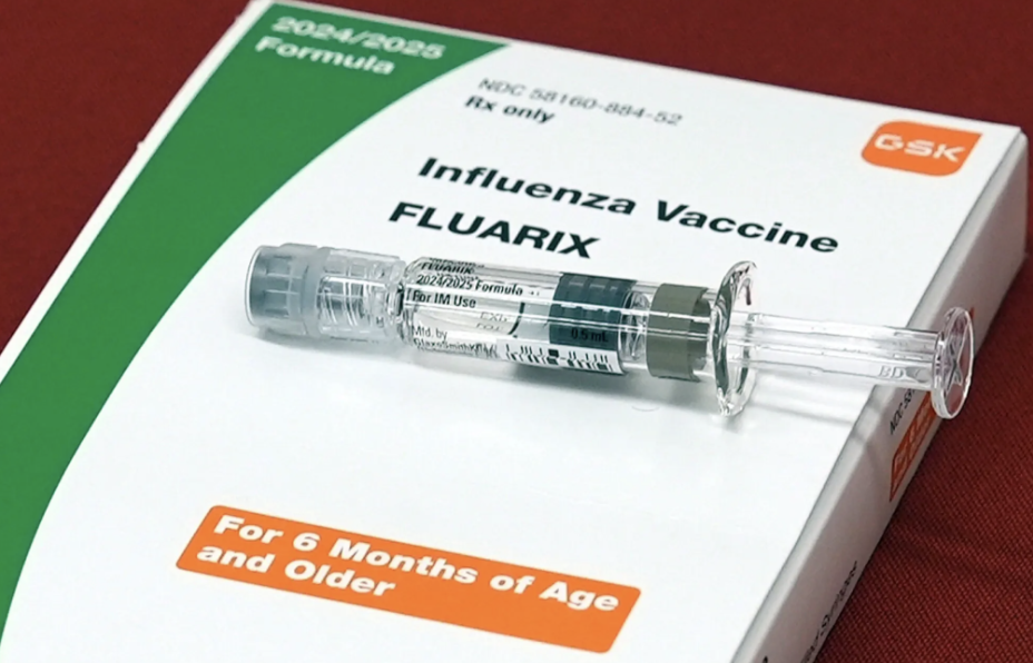 A dose of the influenza vaccine sitting on top of its packaging, which helps protect people against the flu.