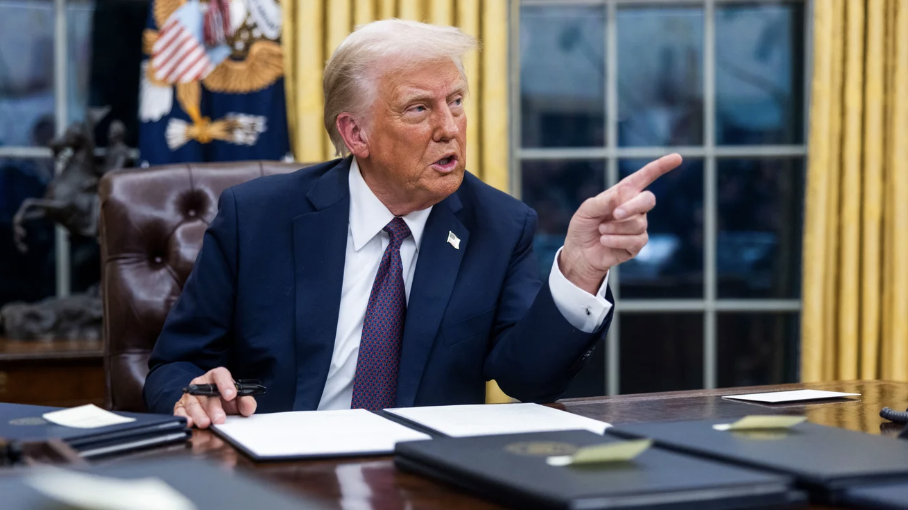 United States President Donald Trump signing executive orders from the Oval Office