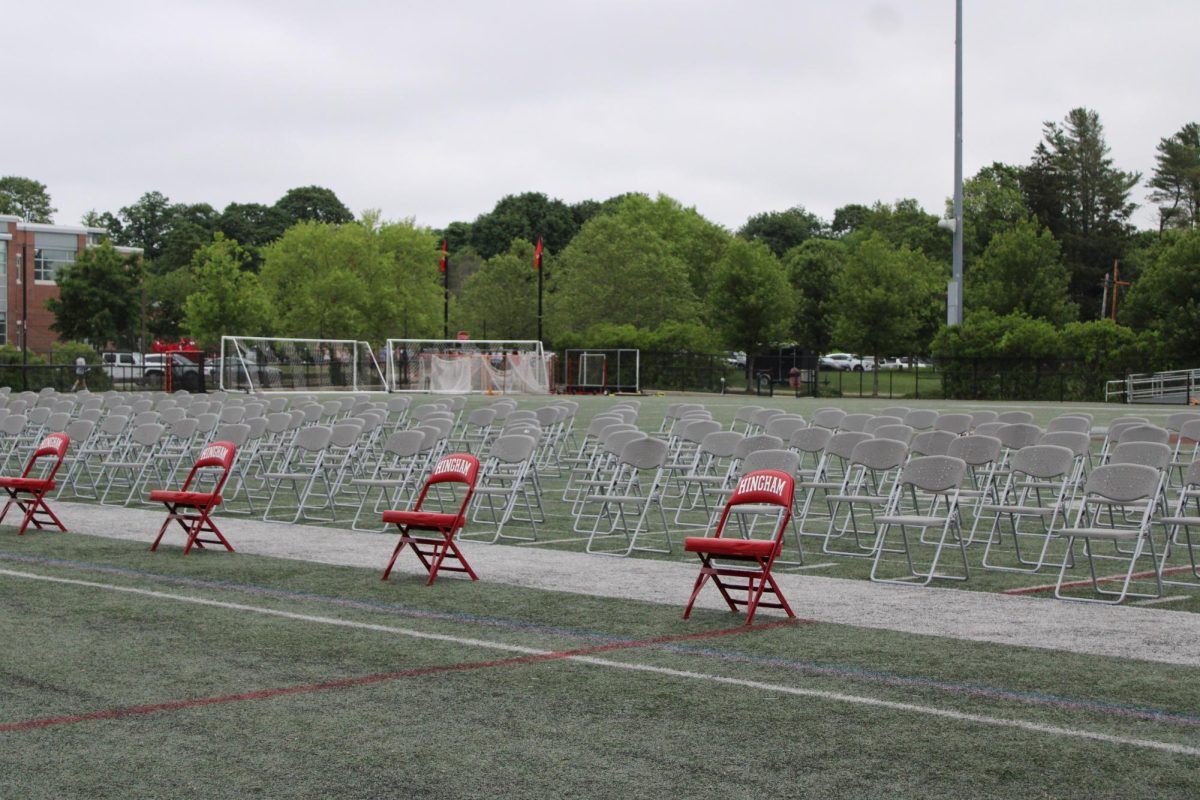 Like the families sitting in the bleachers, the seats on the turf await the graduates' arrival. 