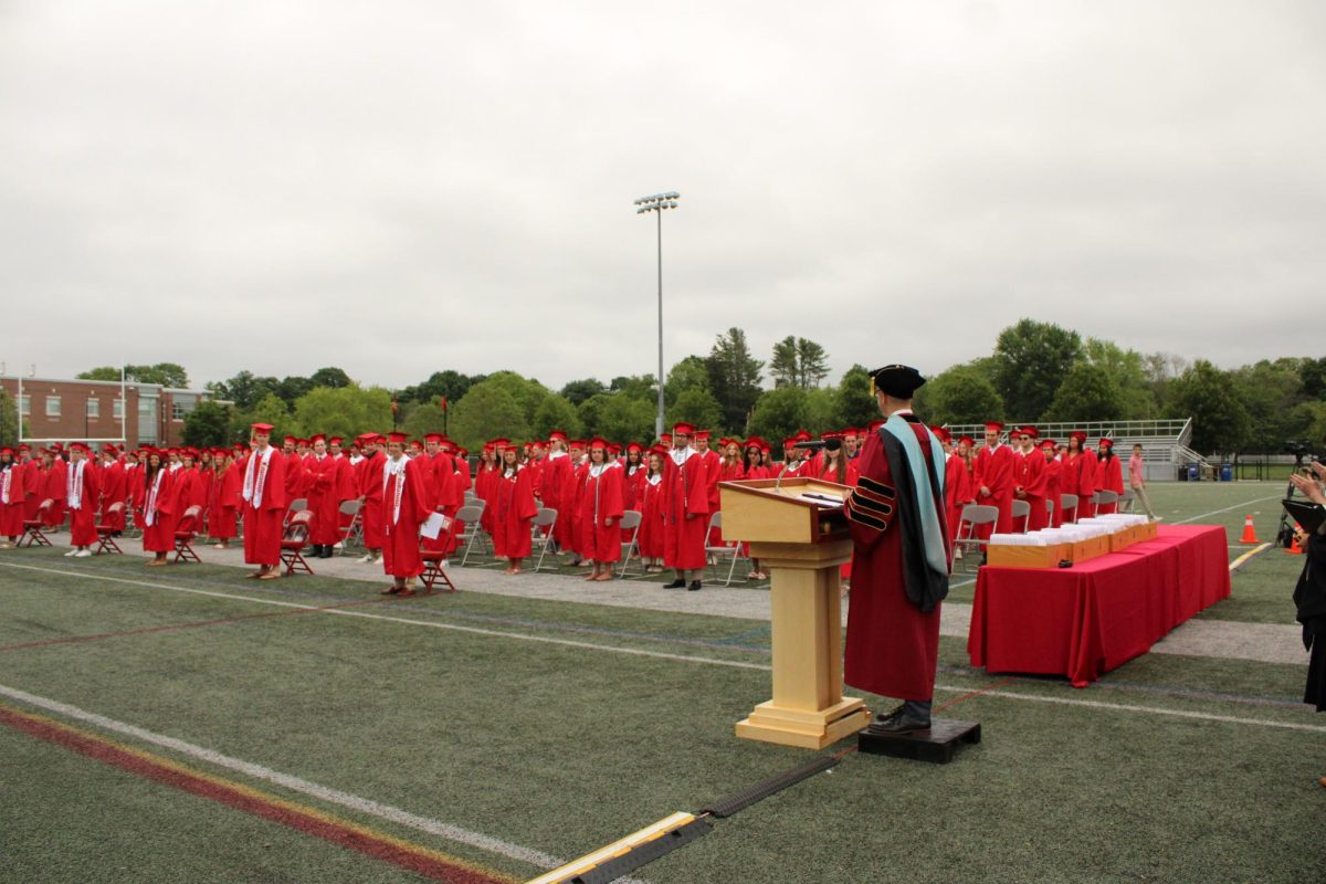 Dr. Buckey, the principal of Hingham High School, addresses the graduating class and audience. 