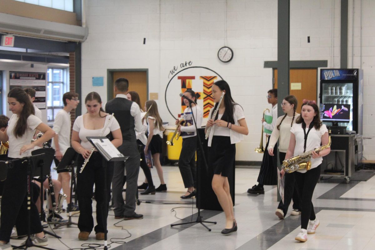 The HMS Jazz Band moves to set up their playing space.