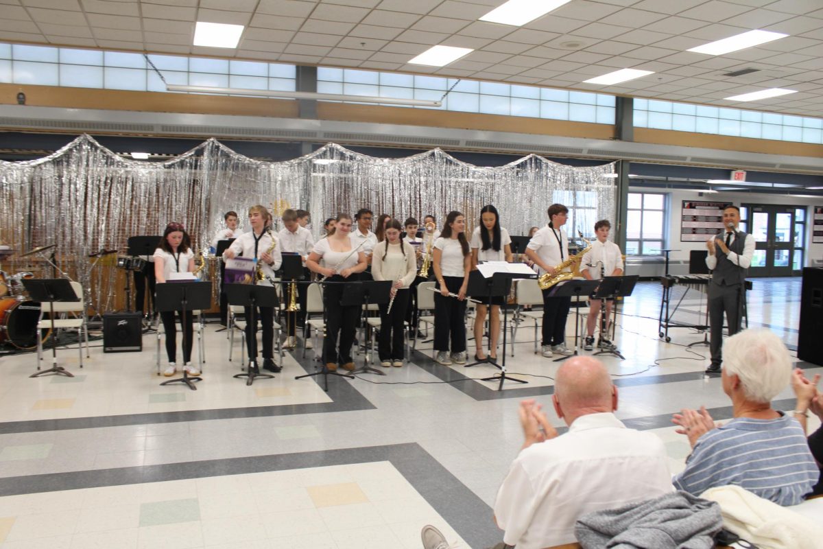 The HMS Jazz Band stands to receive applause.