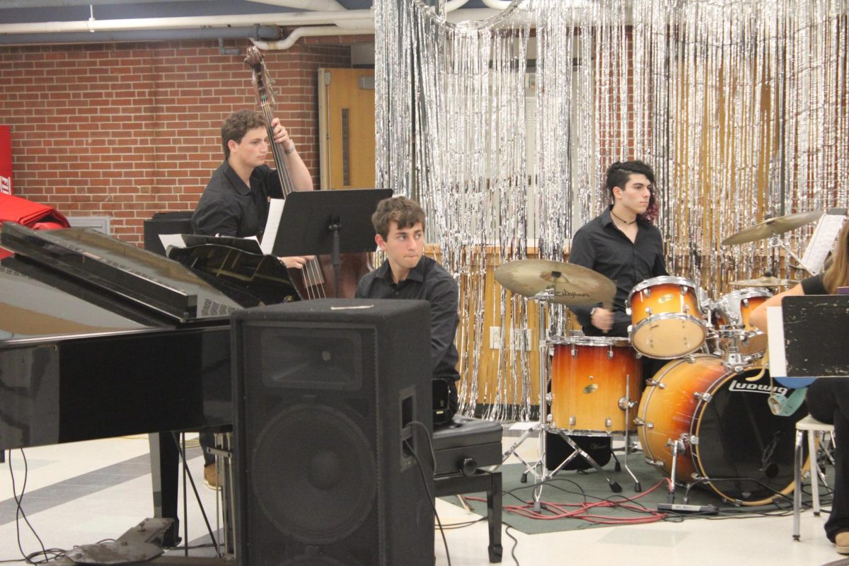 From left to right, Troy Leibovici, Ethan Warhaftig, and Tori Dell play amongst the rest of the band.