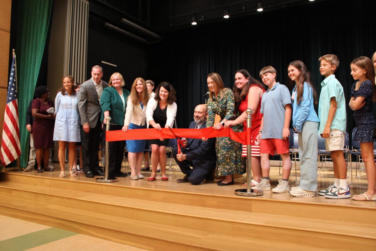 All the speakers gathered with the big scissors to cut the ribbon. 