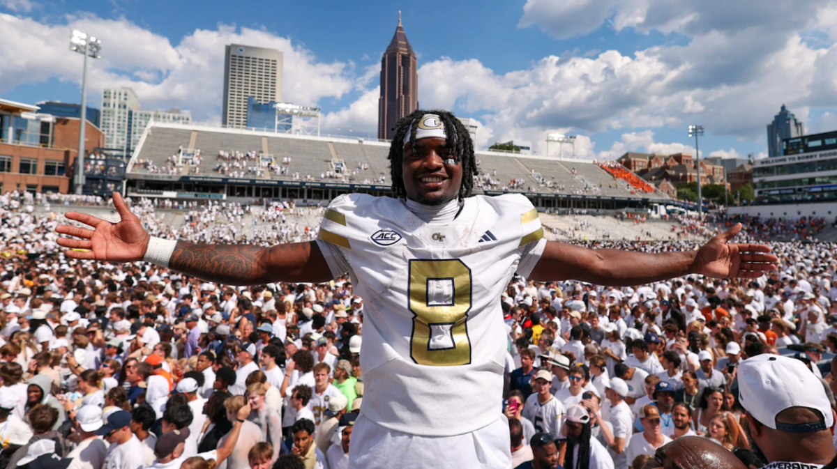 Malik Rutherford celebrates Georgia Tech's upset of #12 Clemson as fans storm the field.