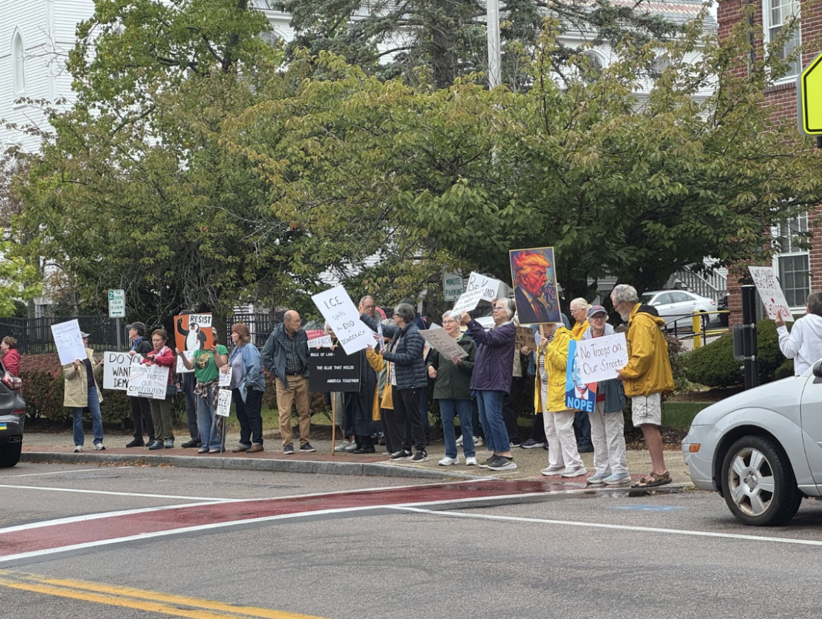 Hingham residents protest the Trump Administration on an early Wednesday morning.