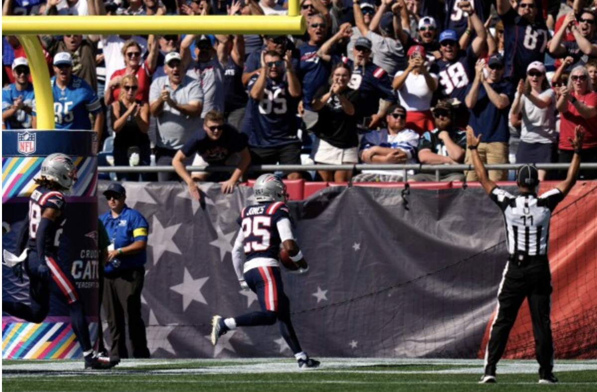 Marcus Jones (#25) and Alex Austin (#28) celebrate in the end-zone with Patriots fans after Jones’ 87-yard touchdown on a punt return. The play gave the Patriots a 7-6 lead over the Carolina Panthers.