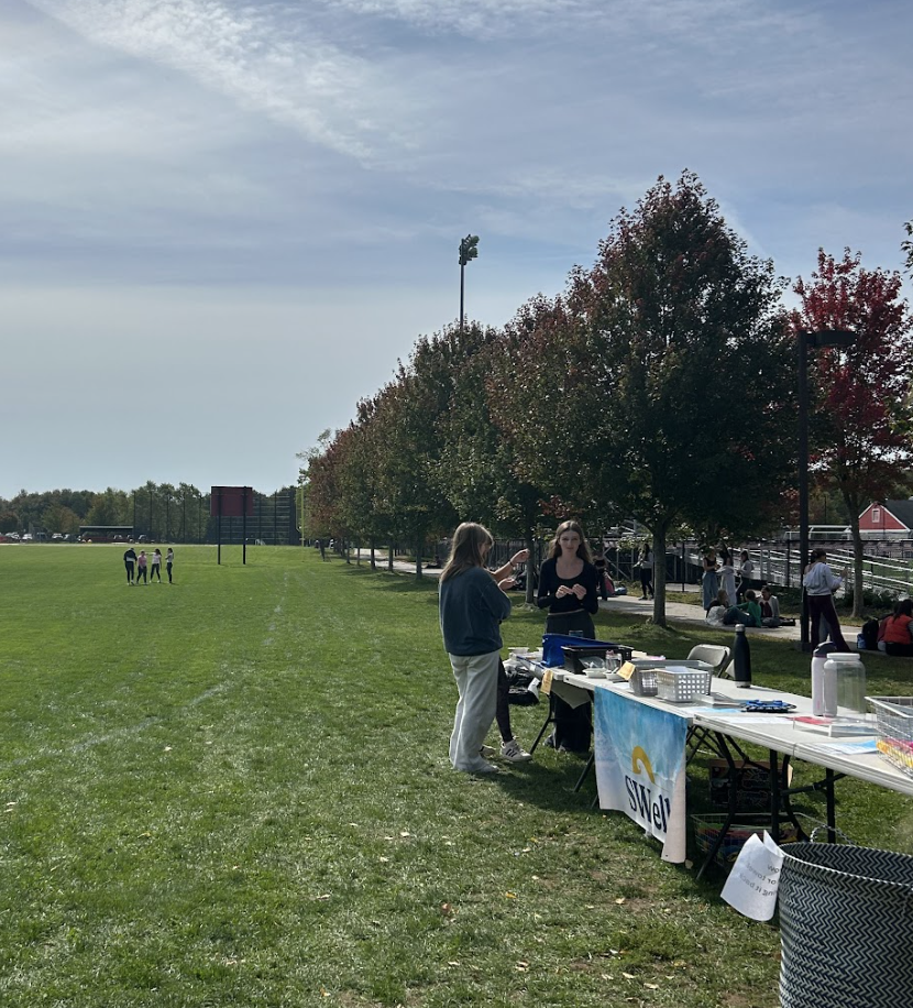 Students from the HHS Breathe Out Club setting up the SWell table in preparation for Breathe Out Day. 