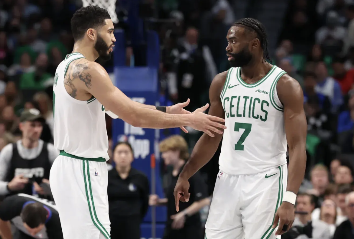 Jayson Tatum and Jaylen Brown of the Boston Celtics talk on the court during the second half of their game against the Dallas Mavericks at American Airlines Center on January 25, 2025.