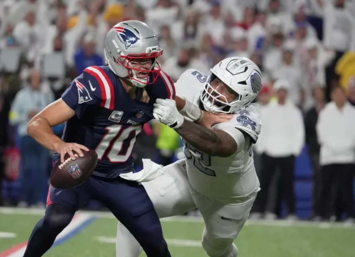Buffalo Bills defensive tackle Daquan Jones (92) tries to force the sack on New England Patriots quarterback Drake Maye (10), but Maye is able to complete the pass.