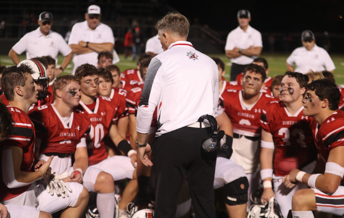 The football team gathers in front of Head Coach TJ Byrne after beating West Springfield 26-7.