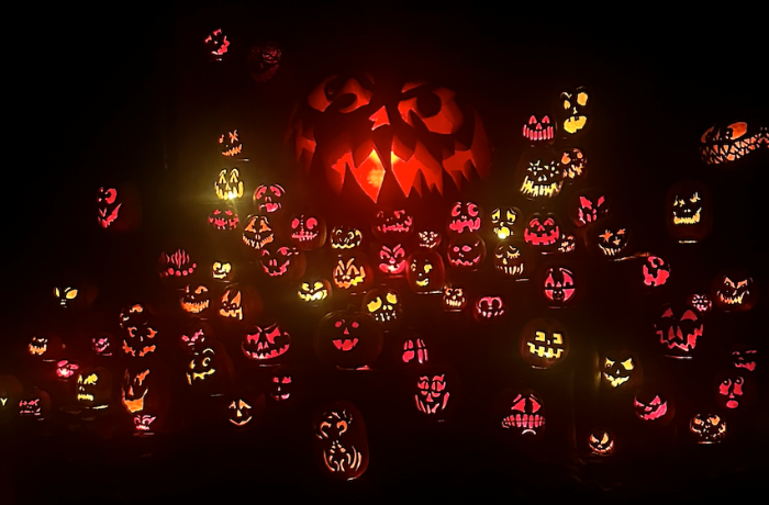 People attend a spooky exhibit of carved pumpkins at the Jack-O-Lantern Spectacular Festival at the Roger Williams Zoo.