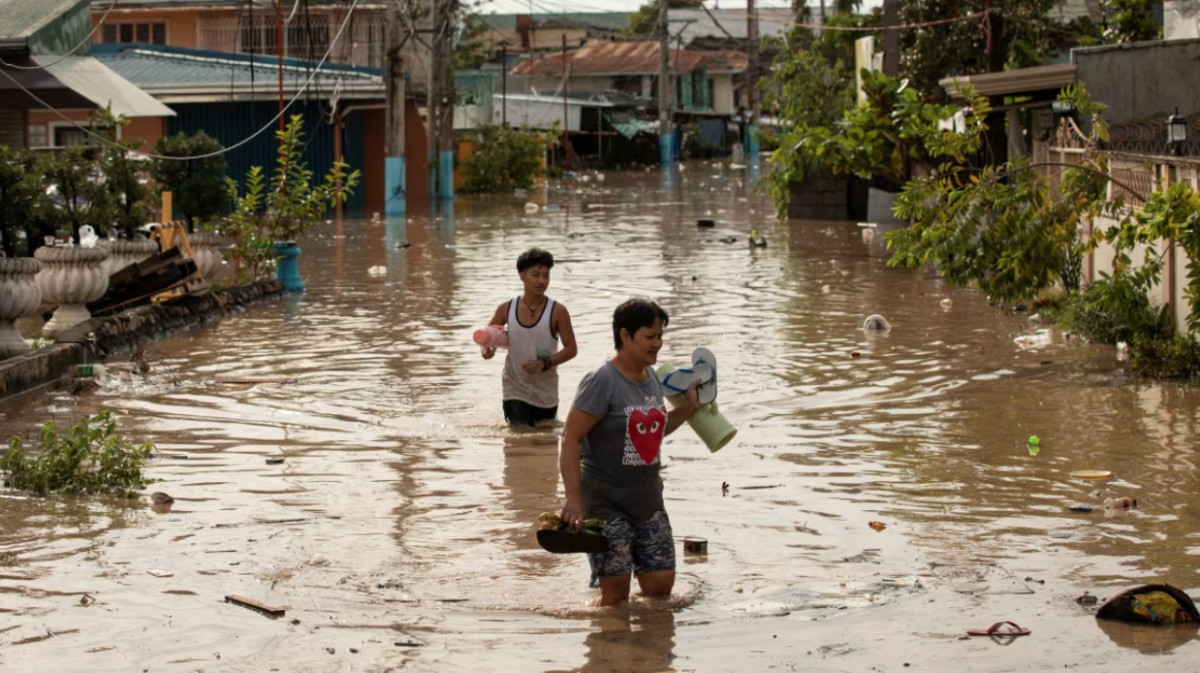 Typhoon Noru’s flooding on September 26 turned streets of San Miguel, Philippines into waterways, forcing people to traverse deep standing water.