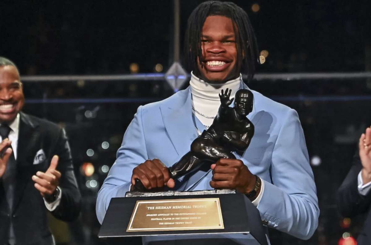 Travis Hunter holds the Heisman Trophy after winning the award following the 2024-2025 college football season.