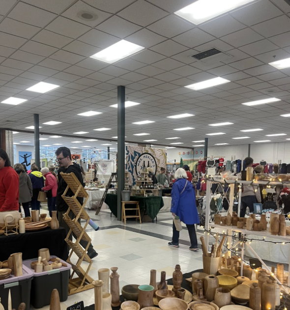 Vendors sell goods as shoppers wander the aisles.