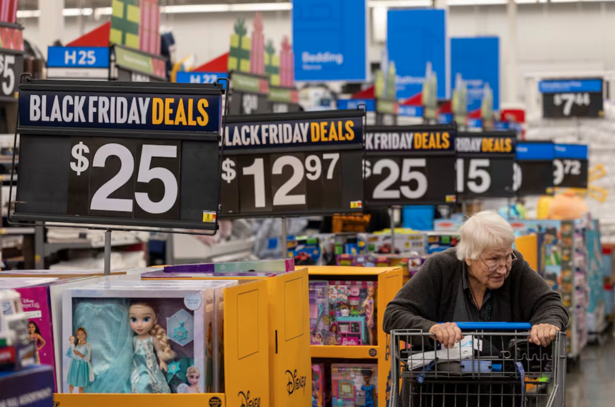 A lone shopper browses the Black Friday deals that stretch along the aisles.