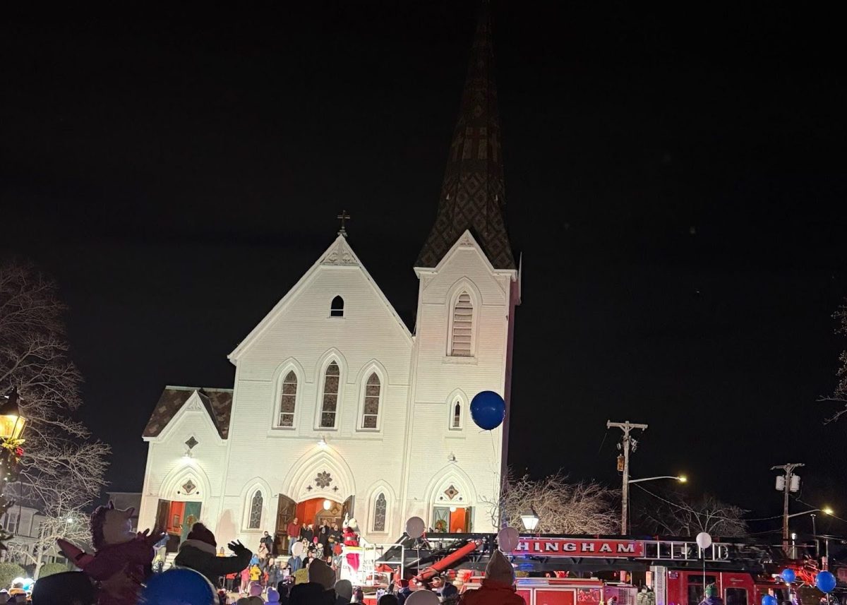 Santa arrives in style as children of all ages try to see him pass.

