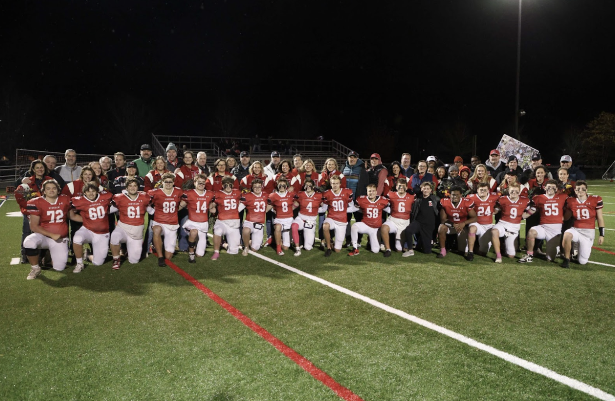 Seniors pose with their families on a senior night win against Silver Lake. 