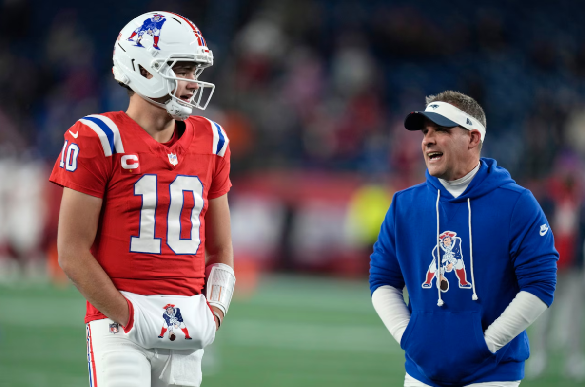 Drake Mayes attentively receives sideline advice from Josh McDaniels.