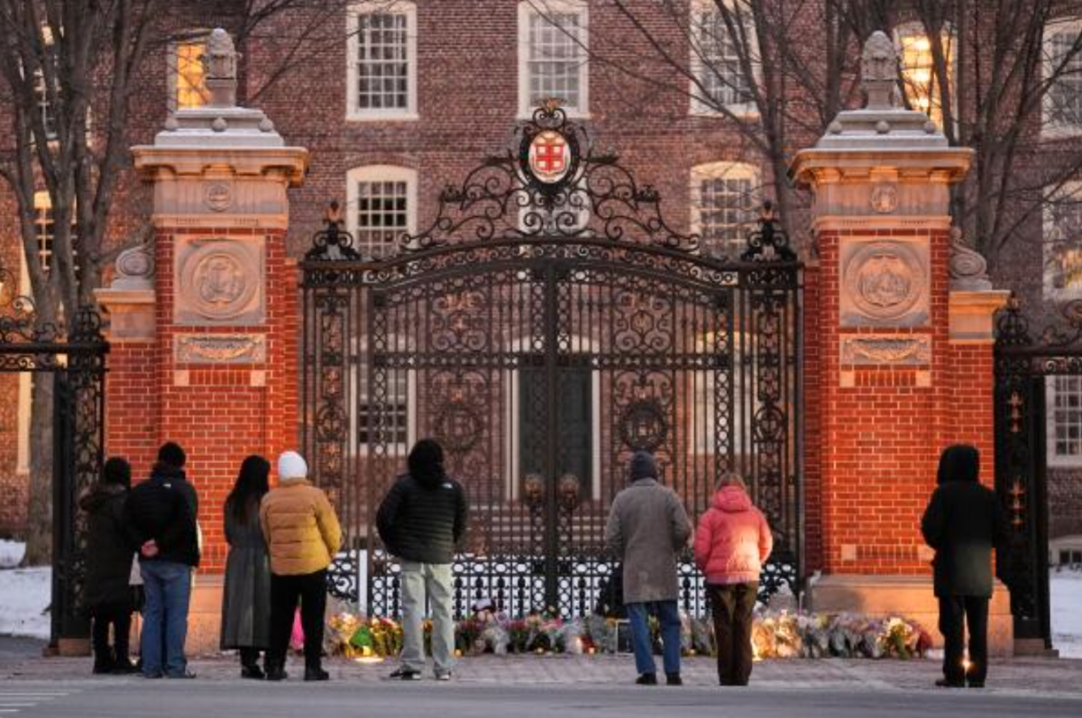 Van Wickle Gate at Brown University has become a memorial for visitors mourning the victims of Saturday’s shooting.