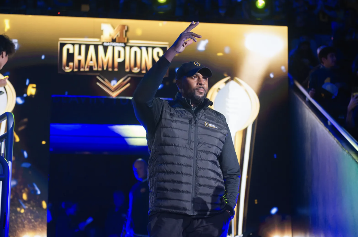 Sherrone Moore celebrating the National Championship win after the 2023 season.