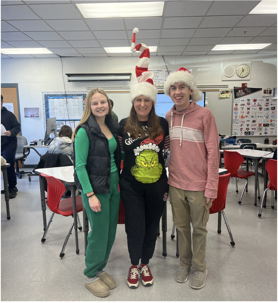 Math teacher, Mrs. Campbell, and her students Alec Whitmore and Ryan Hallisey showing great participation for Tuesday's theme, Grinch vs. Santa.