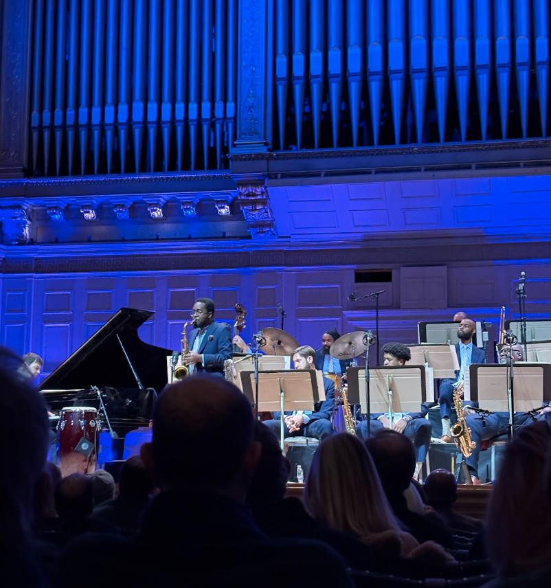 Chris Lewis (tenor saxophone) stands up to play a solo over Duke Ellington’s Togo Brava Suite.