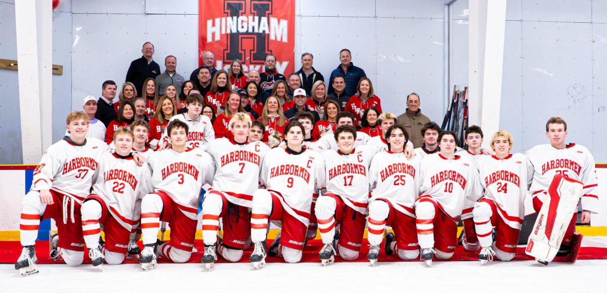 The team and parents gather together for a group photo.