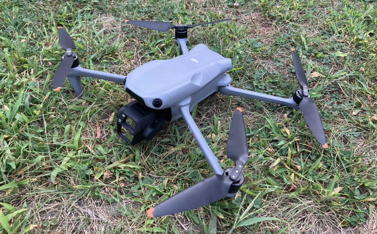 DJI drone rests on the ground before takeoff.
