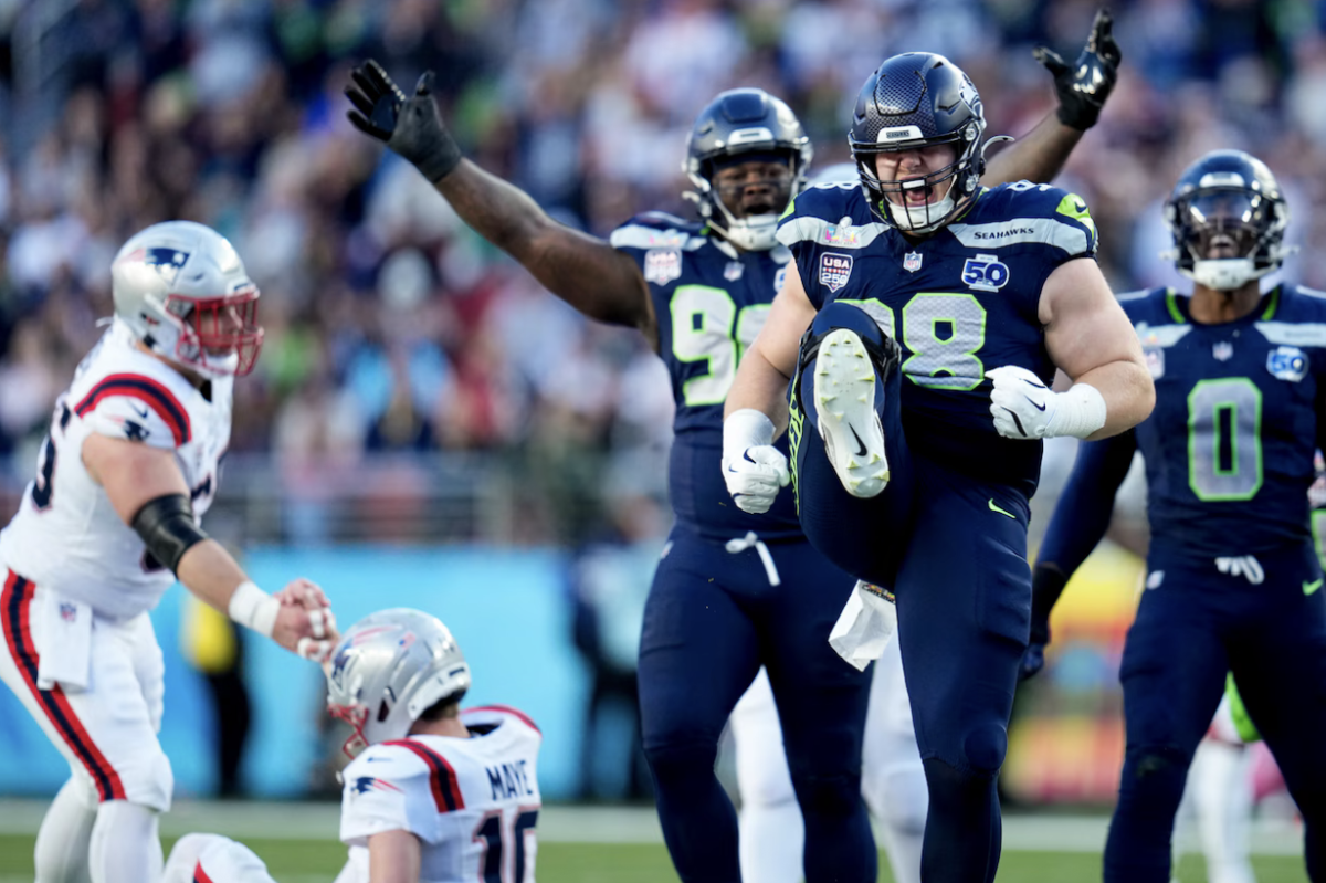 Seahawks defensive end Rylie Mills (98) shows his excitement after sacking Patriots quarterback Drake Maye early on in the first half of Super Bowl 60.