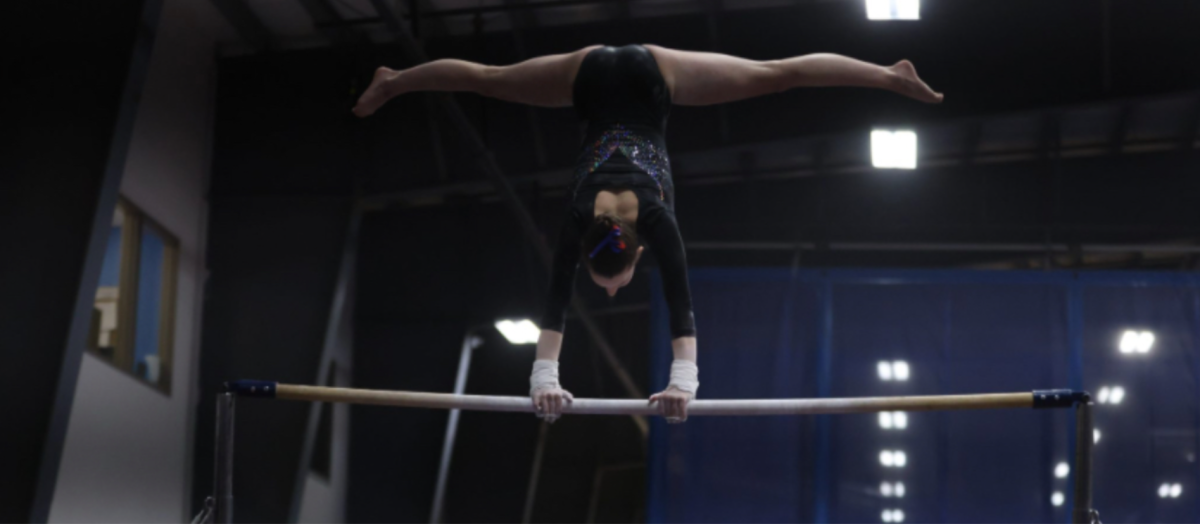 Grace Whiting performing her bar routine at Patriot League meet.