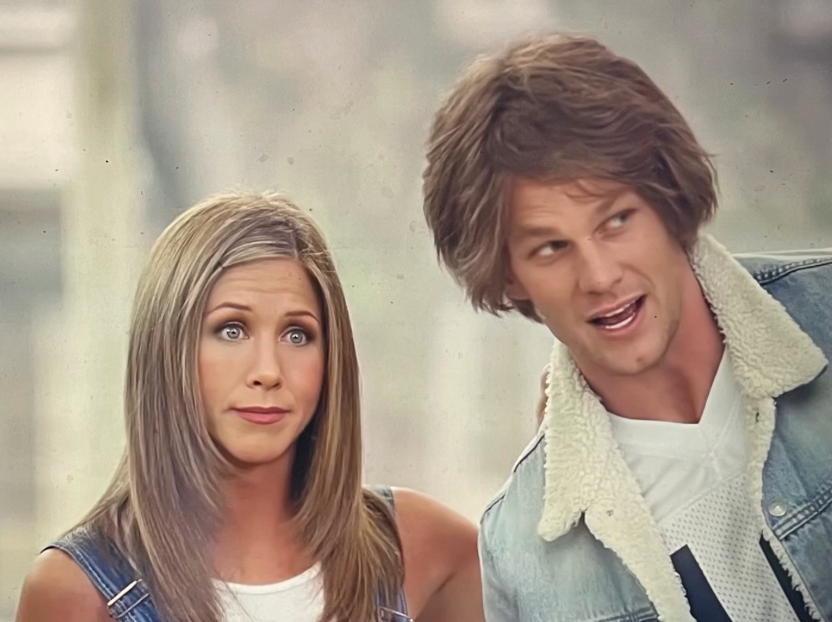 Tom Brady and Jennifer Lawrence look into the Dunkin’ store during the ‘Good Will Dunkin’ advertisement in Super Bowl LX.