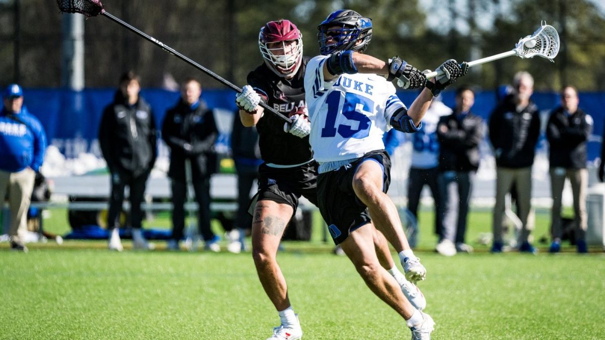 Duke attackman Max Slot shooting a ball into the net, tallying his sixth point in Duke's dominant win on Monday