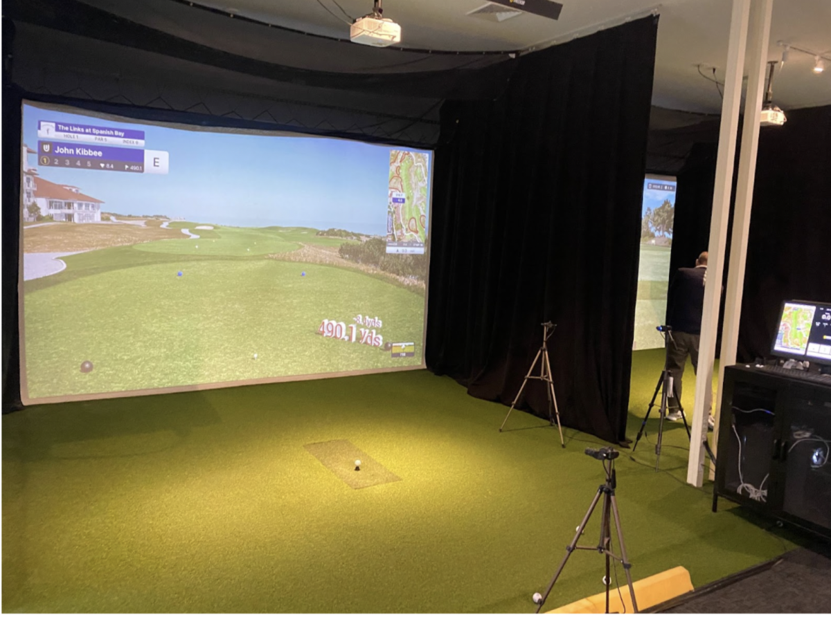 An empty indoor putting simulator awaits use.